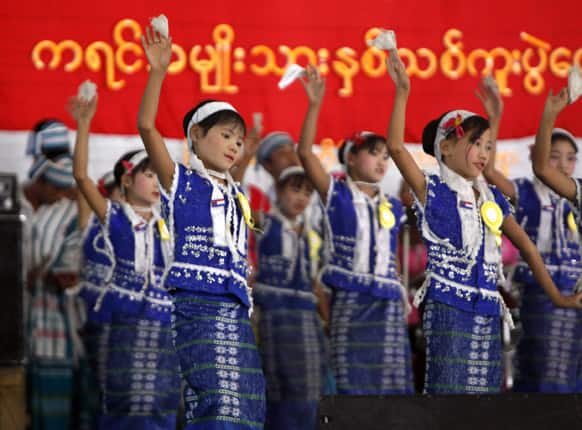 An ethnic Karen children artist troupe, clad in traditional dresses, performs during Karen New Year celebrations at National Race Village in Yangon, Myanmar.