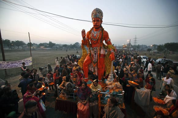 Hindu devotees walk with a chariot carrying a statue depicting the monkey God Hanuman, during a religious procession towards the Sangam, the confluence of rivers Ganges, Yamuna and mythical Saraswati, as part of the Maha Kumbh festival in Allahabad.