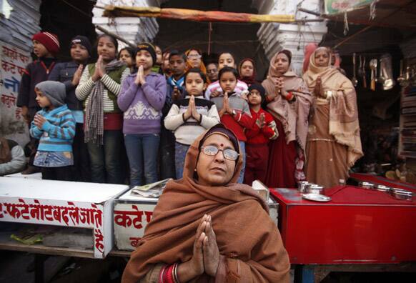 Indians watch a religious procession by Sadhus, or Hindu holy men, towards the Sangam, the confluence of rivers Ganges, Yamuna and mythical Saraswati, as part of the Maha Kumbh festival in Allahabad.