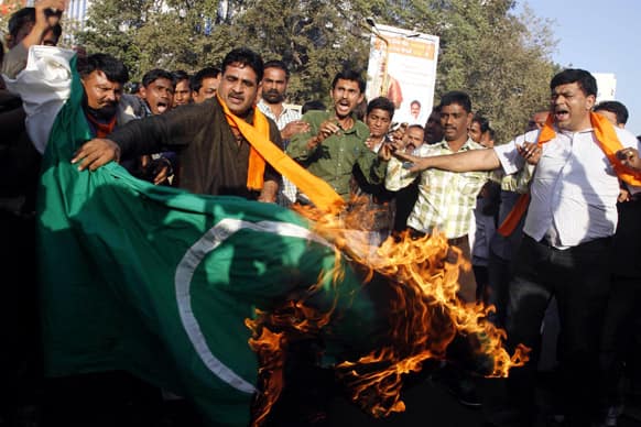 Activists of the right wing Hindu nationalist Vishwa Hindu Parishad, or World Hindu Council, burn a Pakistani flag during a protest in Ahmadabad.