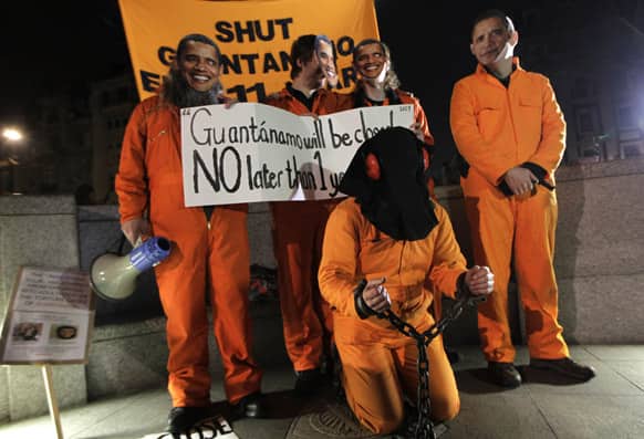 Campaigners gather outside the U.S. Embassy in London, holding various signs against the prison and some wearing US President Obama masks, to mark the 11th anniversary of the opening of Guantanamo Bay US prison in eastern Cuba.