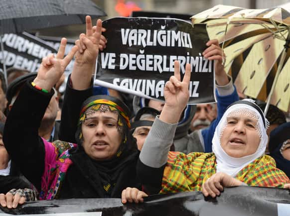Kurds shout slogans praising Sakine Cansiz, one of the founders of a militant group battling Turkish troops since 1984, as they protest against France outside the French consulate in Istanbul, Turkey.