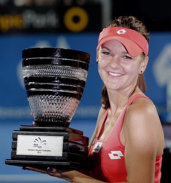 Poland`s Agnieszka Radwanska holds the winner`s trophy after defeating Slovakia`s Dominika Cibulkova in their women`s final match at the Sydney International Tennis tournament in Sydney.