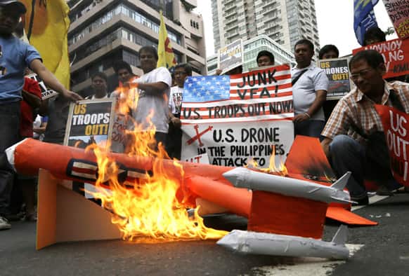 Protesters set on fire to a mock model of a US drone during a rally near the US Embassy in Manila, Philippines.