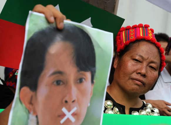 A Kachin protester holds a poster of Myanmar opposition leader Aung San Suu Kyi during a demonstration in front of Myanmar Embassy in Bangkok.