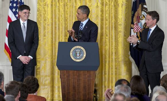President Barack Obama and outgoing Treasury Secretary Timothy Geithner, right, applaud in the East Room of the White House in Washington.