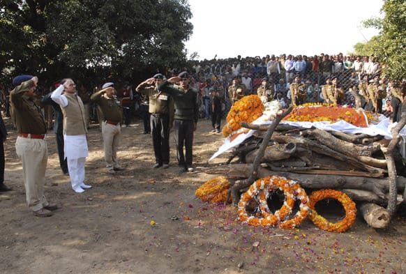 Chief Minister of Madhya Pradesh state Shivraj Singh Chauhan salutes the pyre of Indian army soldier Sudhakar Singh, who died in Kashmir, during his funeral procession in Sidhi district of Madhya Paradesh.