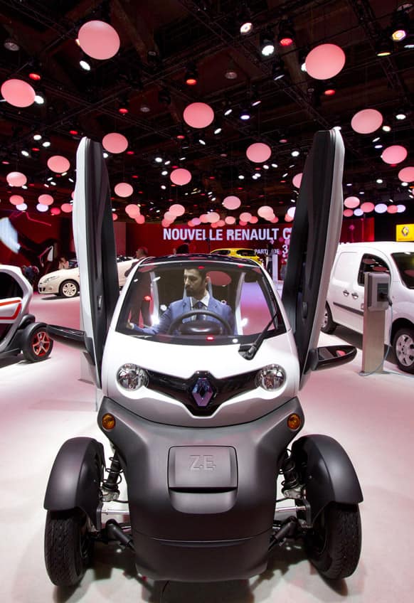 A worker sits in the new Renault Twizy Z.E. during the Brussels Motor Show at the Expo Center in Brussels.