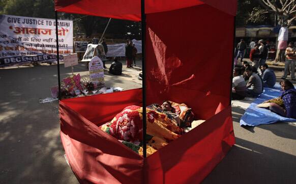Babu Singh lies inside an enclosure on an indefinite hunger strike demanding justice for a gang rape victim in New Delhi.