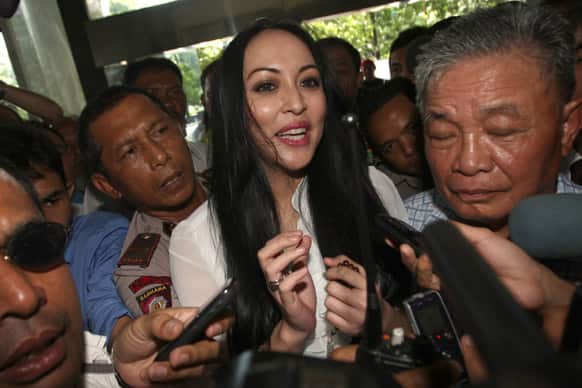 Former Indonesian beauty queen-turned-ruling party politician Angelina Sondakh is mobbed by the media upon arrival for her hearing at the Anti-Corruption Court in Jakarta.
