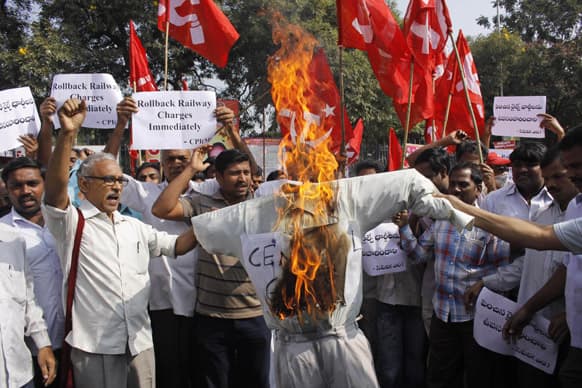 Activists of the Communist Party of India-Marxists(CPI-M) shout slogans and burn an effigy of the ruling United Progressive Alliance government during a protest against hike in rail fares in Hyderabad.