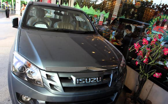 A new Isuzu pickup truck is displayed outside a shopping mall in Bangkok. Isuzu Motors Ltd. and its former shareholder General Motors Co. said Thursday that they plan to jointly develop new pickup truck models, reviving cooperation with an eye to fast-growing emerging markets.