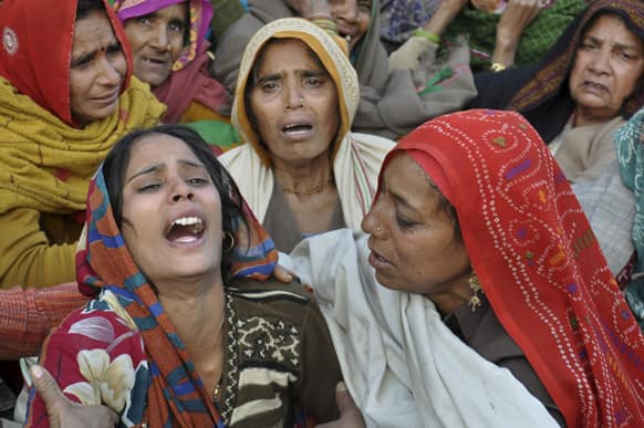 The wife of Indian Army soldier Lance Naik Hamraj, left, who was allegedly killed by Pakistani soldiers on the line-of-control in Kashmir, mourns before his funeral in Mathura district, Utter Pradesh, India.