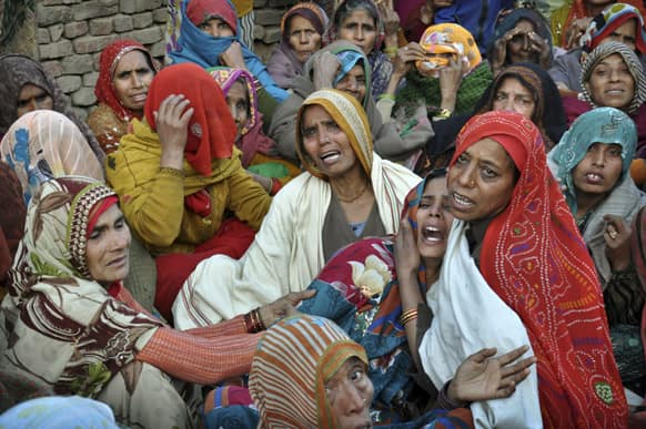 The wife of Indian Army soldier Lance Naik Hamraj, left, who was allegedly killed by Pakistani soldiers on the line-of-control in Kashmir, mourns before his funeral in Mathura district, Utter Pradesh, India.