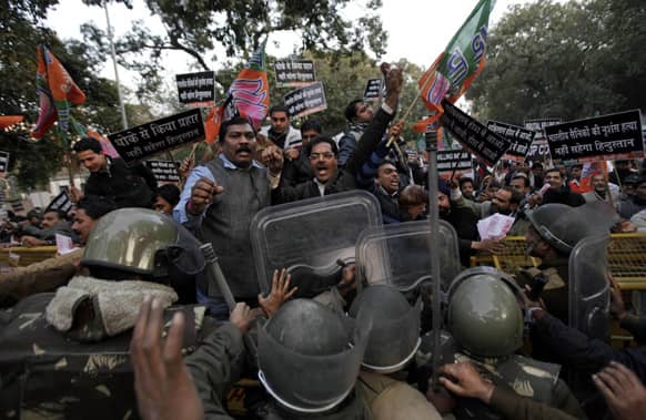 Supporters of India`s main opposition Bharatiya Janta Party (BJP) shout slogans as they try to cross a police barricade during a protest against Pakistan in New Delhi, India.
