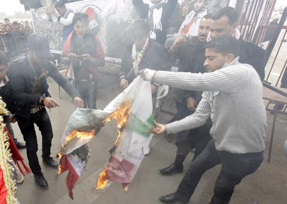 Protesters burn an Iranian flag during a demonstration in Ramadi, 70 miles (115 kilometers) west of Baghdad, Iraq.