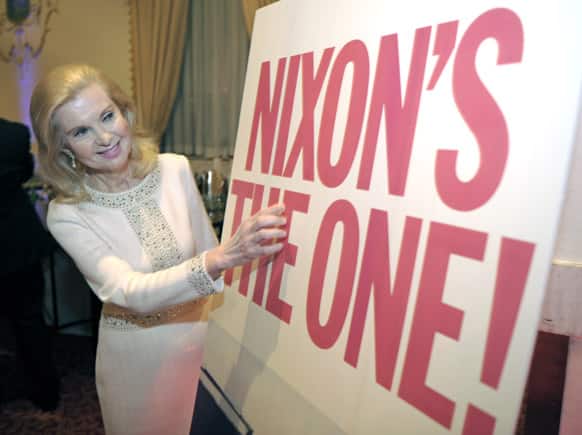 Trisha Nixon Cox, daughter of President Richard Nixon, looks at a reproduction of one of her father`s campaign signs during the Richard Nixon Centennial Birthday Celebration in Washington.