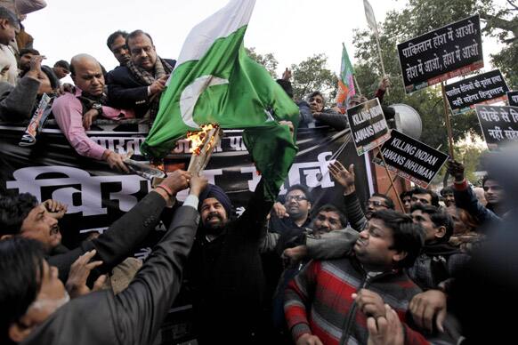 Supporters of BJP set a Pakistani flag on fire during a protest against Pakistan in New Delhi. India summoned Pakistan`s top diplomat in New Delhi to formally complain about an attack on an Indian army patrol in Kashmir that killed two soldiers.