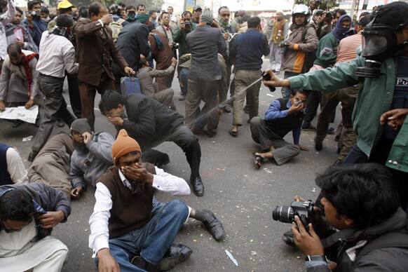 Riot police use teargas spray to disperse Bangladeshi non-government school teachers during a demonstration in Dhaka.
