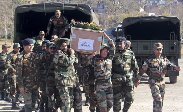 Indian army soldiers carry a coffin containing the body of a colleague who was allegedly killed by Pakistani soldiers, in Rajouri.