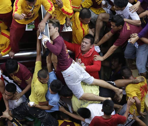 A Catholic devotee manages to get closer to kiss the rear end of the cross of the centuries-old image of the Black Nazarene in a raucous celebration on its feast day in Manila, Philippines.