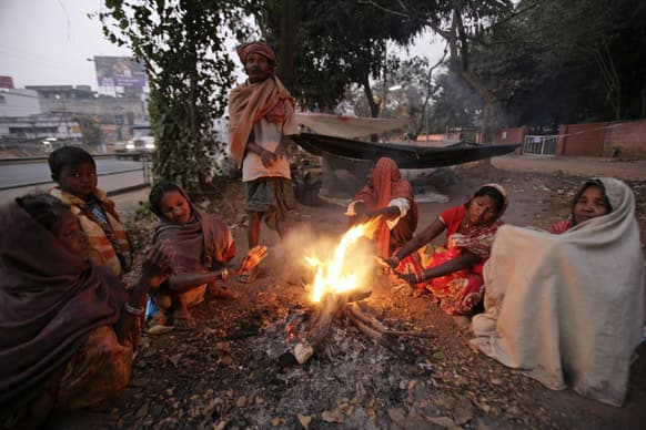 Homeless people keep warm around a bonfire on a cold morning in Bhubaneswar. More than 100 people have died of exposure as parts of the country deal with historically cold temperatures.