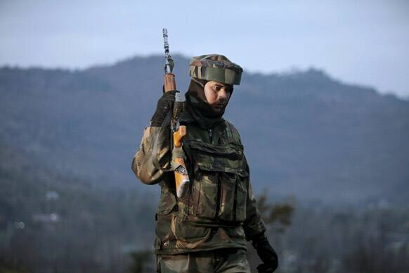 An Indian army soldier patrols near the line of control after a reported cease-fire violation, in Mendhar, Poonch district, about 210 kilometers (131 miles) from Jammu.