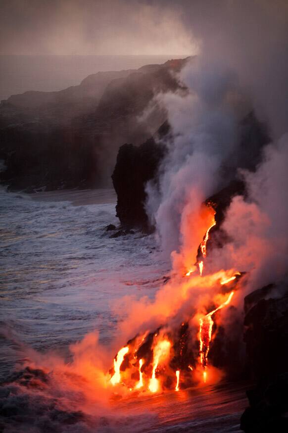 Lava from the Puu Oo cone of Kilauea Volcano reaches the Pacific Ocean on the southeastern coast of Hawaii Island, Hawaii.