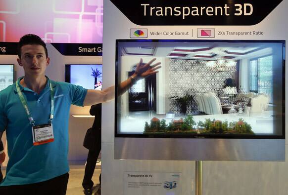 Payton Tyrell demonstrates on a transparent 3D TV at the Hisense booth at the International Consumer Electronics Show in Las Vegas.