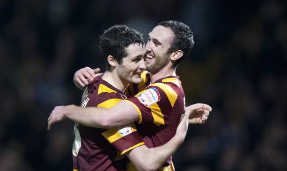 Bradford City`s Rory McArdle, right, celebrates with fellow goal scorer Carl McHugh after their 3-1 win over Aston Villa in their English League Cup semifinal soccer match.
