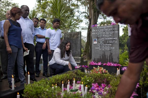 Extended family members, friends and law-makers pay tribute at the grave of slain newspaper editor Lasantha Wickrematunge, on his fourth death anniversary in Colombo, Sri Lanka.