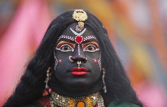 A man, dressed as Hindu Goddess Kali, participates in a religious procession towards the Sangam, the confluence of rivers Ganges, Yamuna and mythical Saraswati, as part of the Mahakumbh festival in Allahabad.