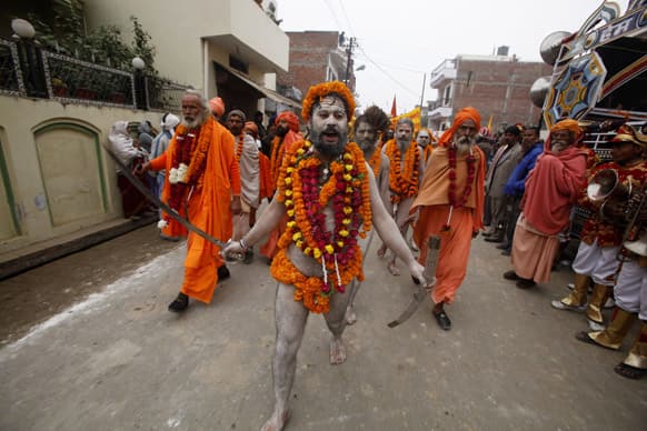 Naga Sadhus, or naked Hindu holy men of the Anand Akhada group, participate in a religious procession towards the Sangam, the confluence of rivers Ganges, Yamuna and mythical Saraswati, as part of the Mahakumbh festival in Allahabad.