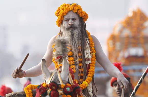 A Naga Sadhus, or Naked Hindu holy man, participate in a religious procession towards the Sangam, the confluence of rivers Ganges, Yamuna and mythical Saraswati, as part of the Mahakumbh festival in Allahabad.