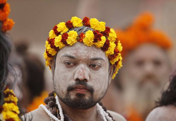 A Naga Sadhu, or Naked Hindu holy man, takes part in a religious procession towards the Sangam, the confluence of rivers Ganges, Yamuna and mythical Saraswati, as part of the Mahakumbh festival in Allahabad.