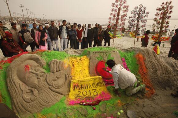 Artist Rajkapoor Chitera makes a sand sculpture during preparations for the Maha Kumbh festival in Allahabad.