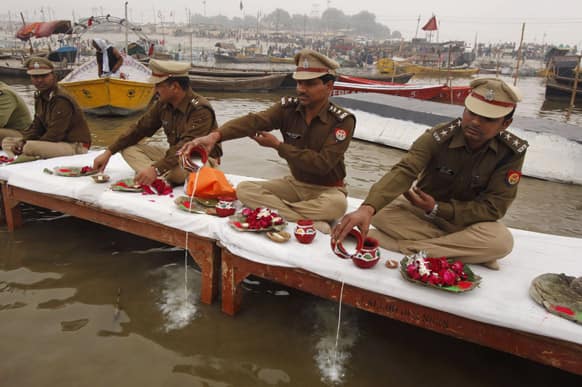 Indian policemen offer prayers to the River Ganges during preparations for the Maha Kumbh festival in Allahabad.