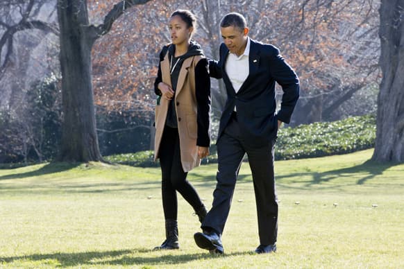 President Barack Obama walks with daughter Malia on the first family`s return from vacationing in Hawaii, on the South Lawn of the White House in Washington.