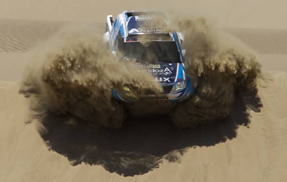 Totoya`s Lucio Alvarez and co-driver Bernardo Graue of Argentina compete in the 1st stage of the 2013 Dakar Rally between Lima Pisco, Peru.