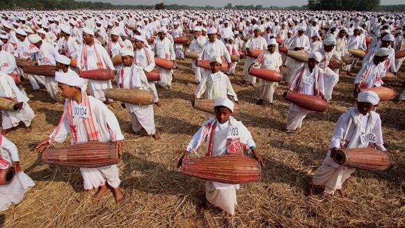 Indians wearing traditional Assamese attire play the khol, a traditional percussion instrument of Assam, as they participate in an attempt to create a Guinness record, in Titabar, about 350 kilometers (219 miles) east of Gauhati.