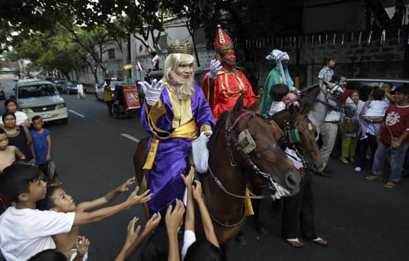 Filipino kids scramble to get candies given by men dressed as the Three Kings during Epiphany celebrations in Manila.