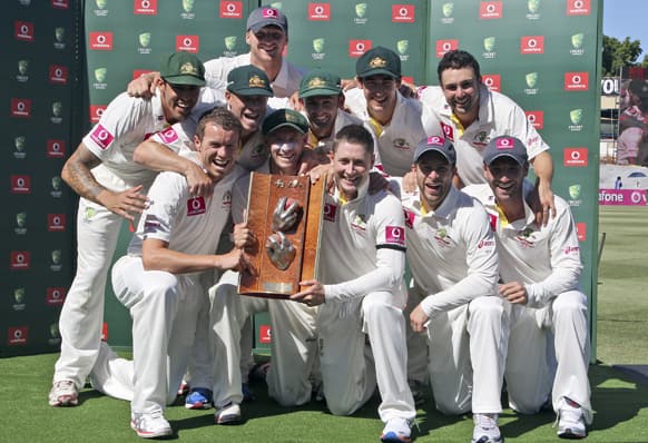 Australian team members celebrate after they won their third cricket test match against in Sydney. Australia won the match and the series 3-0.