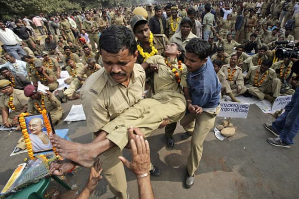 Orissa state home guards carry an unconscious colleague after she fainted on the third day of their indefinite hunger strike in Bhubaneswar. Hundreds of home guards are on a hunger strike demanding a pay hike and reinstatement of some retrenched home guards.