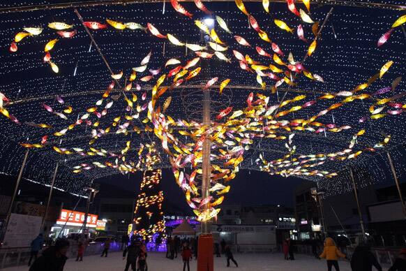 Trout-shaped lamps are displayed during a contest to catch trout at an ice link in Hwacheon, South Korea. The contest is part of an annual ice festival which draws over 1,000,000 visitors every year.