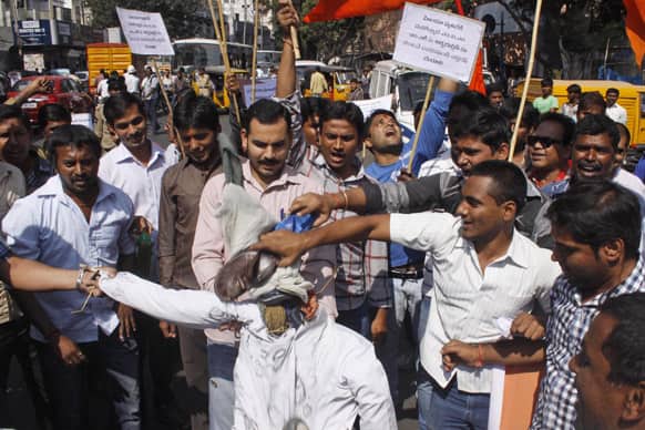 Activists of the right-wing Hindu nationalist Vishwa Hindu Parishad (VHP) shout slogans and beat an effigy of Majlis-e-Ittehadul Muslimeen (MIM) leader Akbaruddin Owaisi during a protest against his alleged hate speech in Hyderabad.