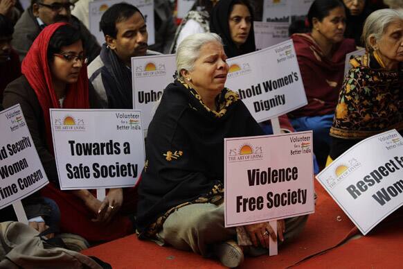 A woman cries while singing devotional songs during a gathering to mourn the death of a 23-year old rape victim in New Delhi.