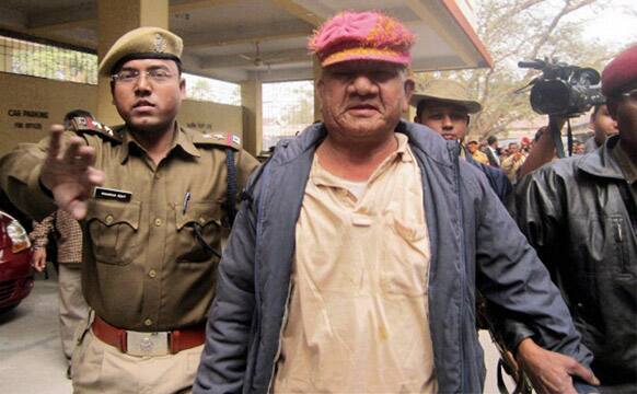 A leader of the ruling Congress party Bikram Singh Brahma, centre, is escorted to a court after allegations leading to his arrest on accusations he raped a woman, in Kokrajhar in the northeastern Indian state of Assam.