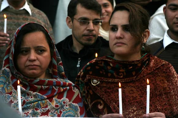 Pakistan NGO workers hold rally outside the Peshawar Club for their colleagues killed by gunmen, in Peshawar.