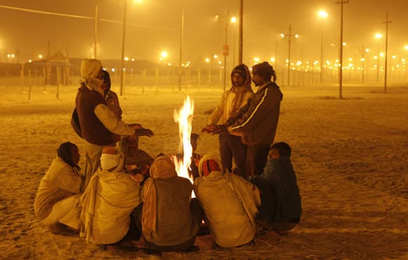 Indians warm themselves around a bonfire at the Sangam, the confluence of rivers Ganges, Yamuna and the mythical Saraswati in Allahabad.