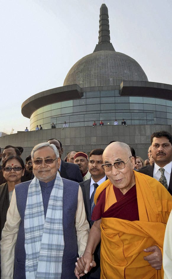 Tibetan spiritual leader the Dalai Lama, right, walks with Chief Minister of Bihar state Nitish Kumar at the Patliputra Karuna Stupa in Patna.